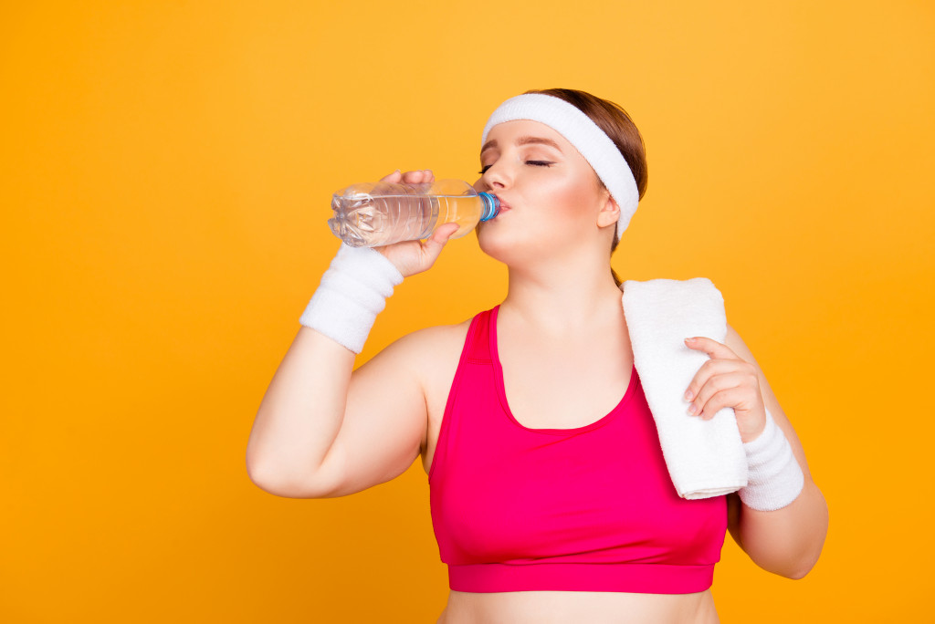 woman in working outfit driniking water