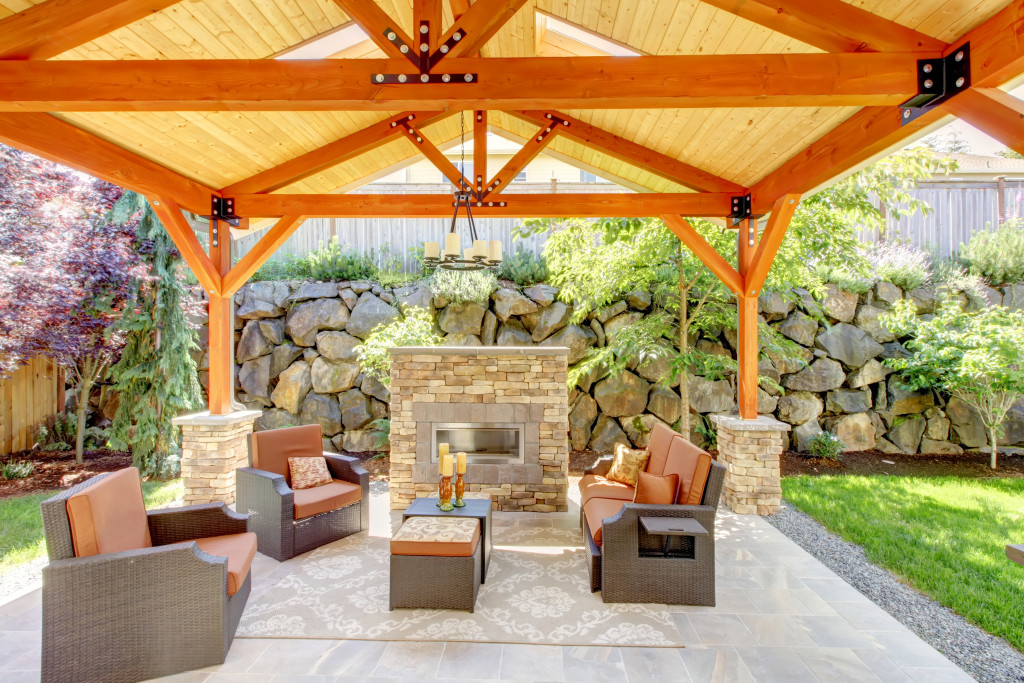a nice backyard with orange canopy with comfortable sofas
