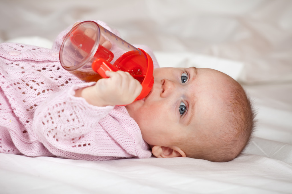a child with a feeding bottle