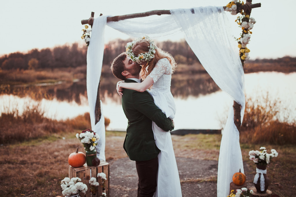 outdoor wedding with bride and groom kissing