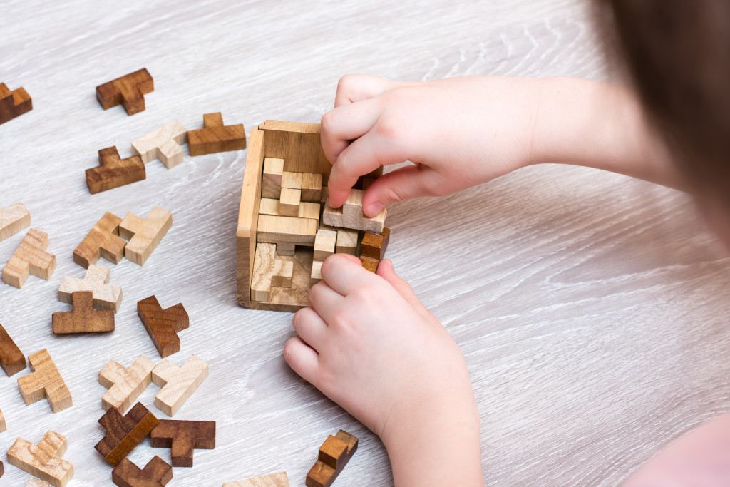 A child playing with a wooden puzzle