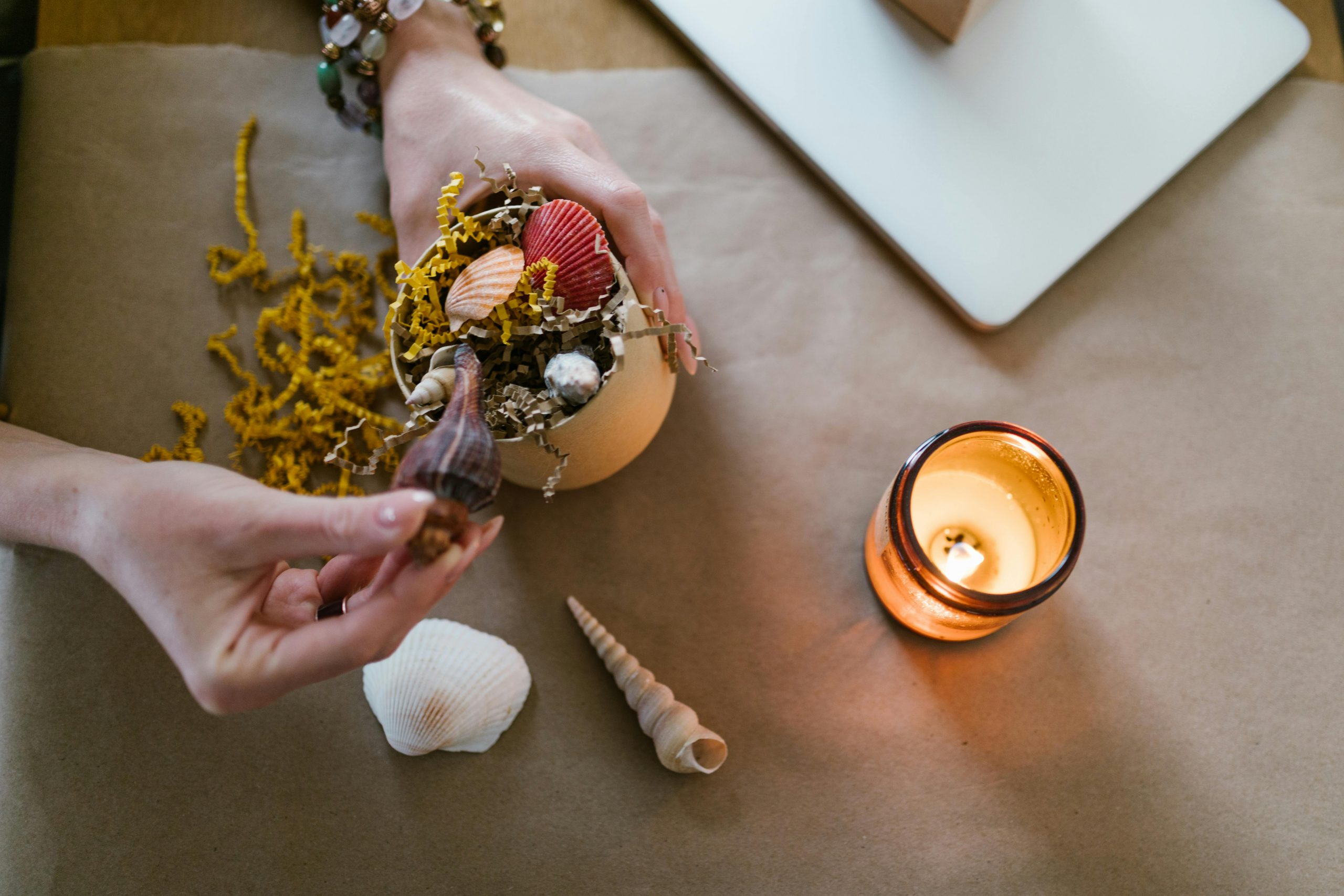 woman creating home decor using seashells
