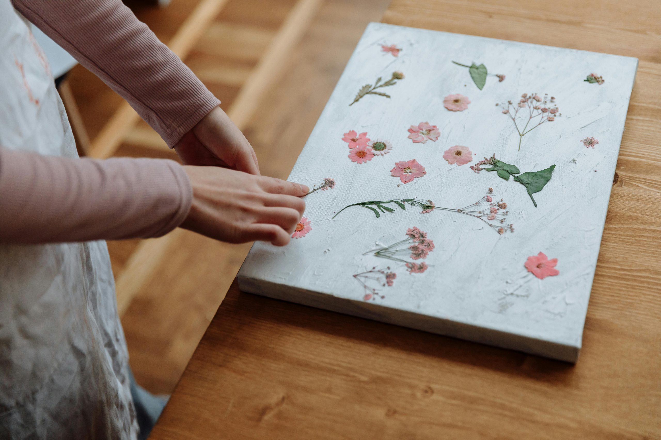 woman creating pressed flower art